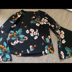 Black floral top with flared sleeves